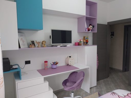 Camera setup with a desk, purple chair, and a wall-mounted TV in a modern room.